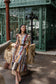 Alden Adair Luna Dress Golden Bouquet patchwork floral midi dress with brown belt and puff sleeves, front view on model outdoors.