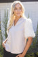 The Faux Feather Top Cream by The Faux Feather, featuring fluffy feather-textured short sleeves and a V-neckline.