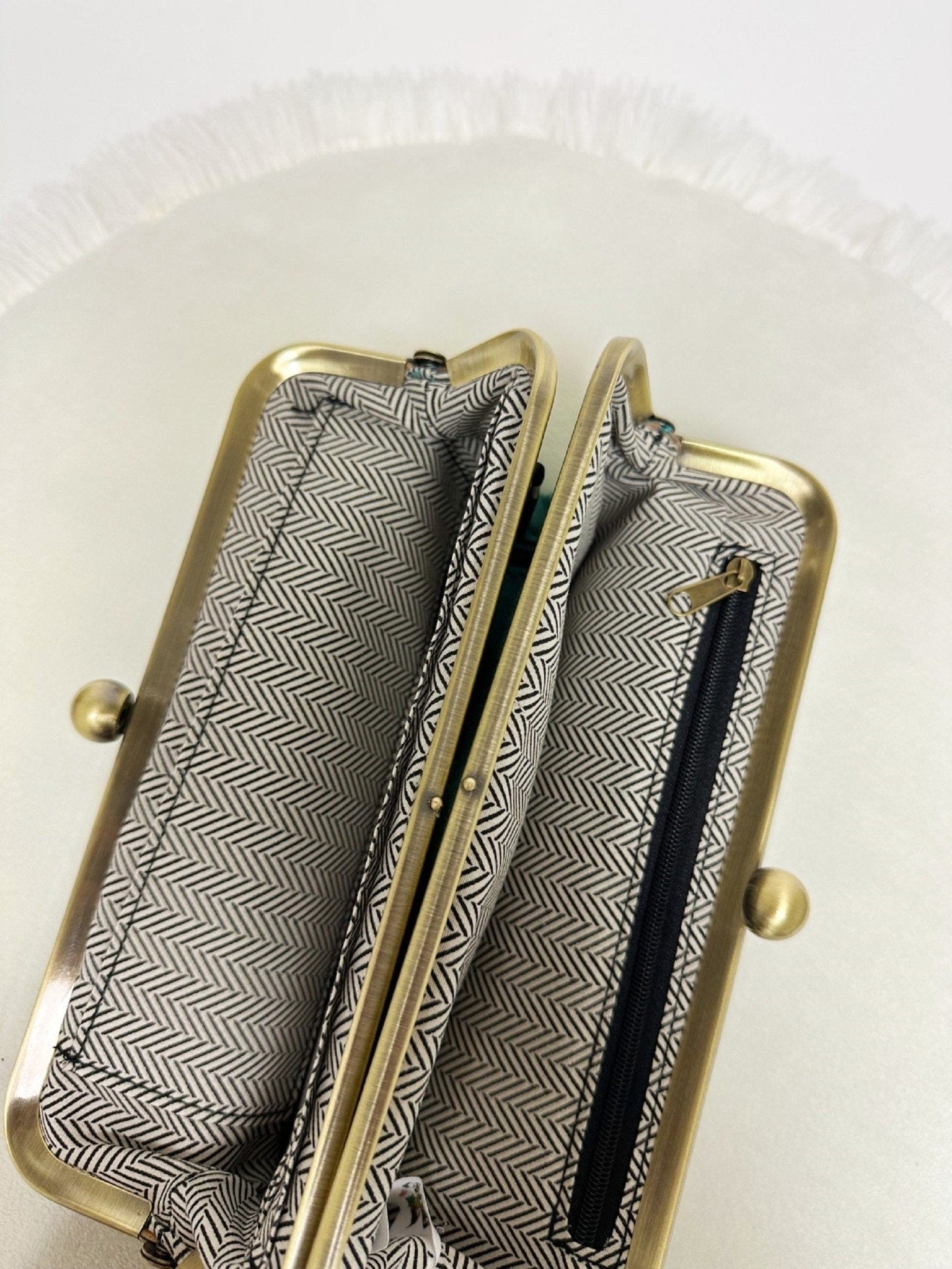 MiMi Wholesale Karen Kiss Lock Clutch BP208 interior view showing herringbone lining, gold frame, card slots, and zip pocket