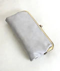 Karen Kiss Lock Clutch in Pearl Gray with gold-tone metal frame closure and smooth leather exterior