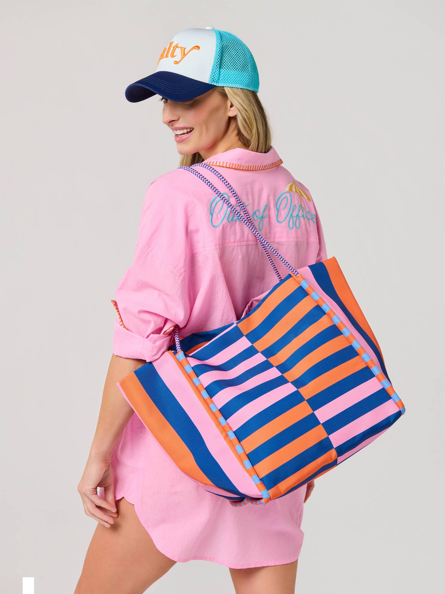 Salty brand large striped tote bag in pink, blue, and orange checkered pattern with rope handles.