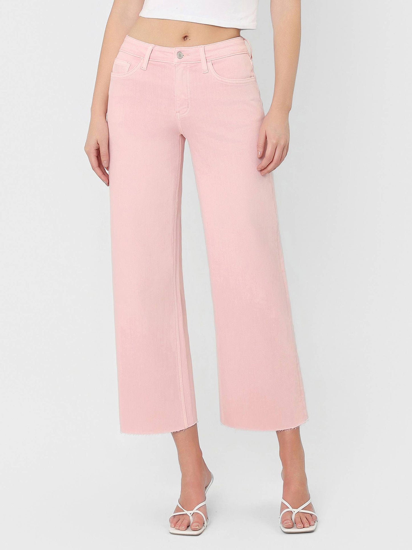 High Rise Crop wide leg cropped jeans in bubblegum pink with raw hem and silver button closure.