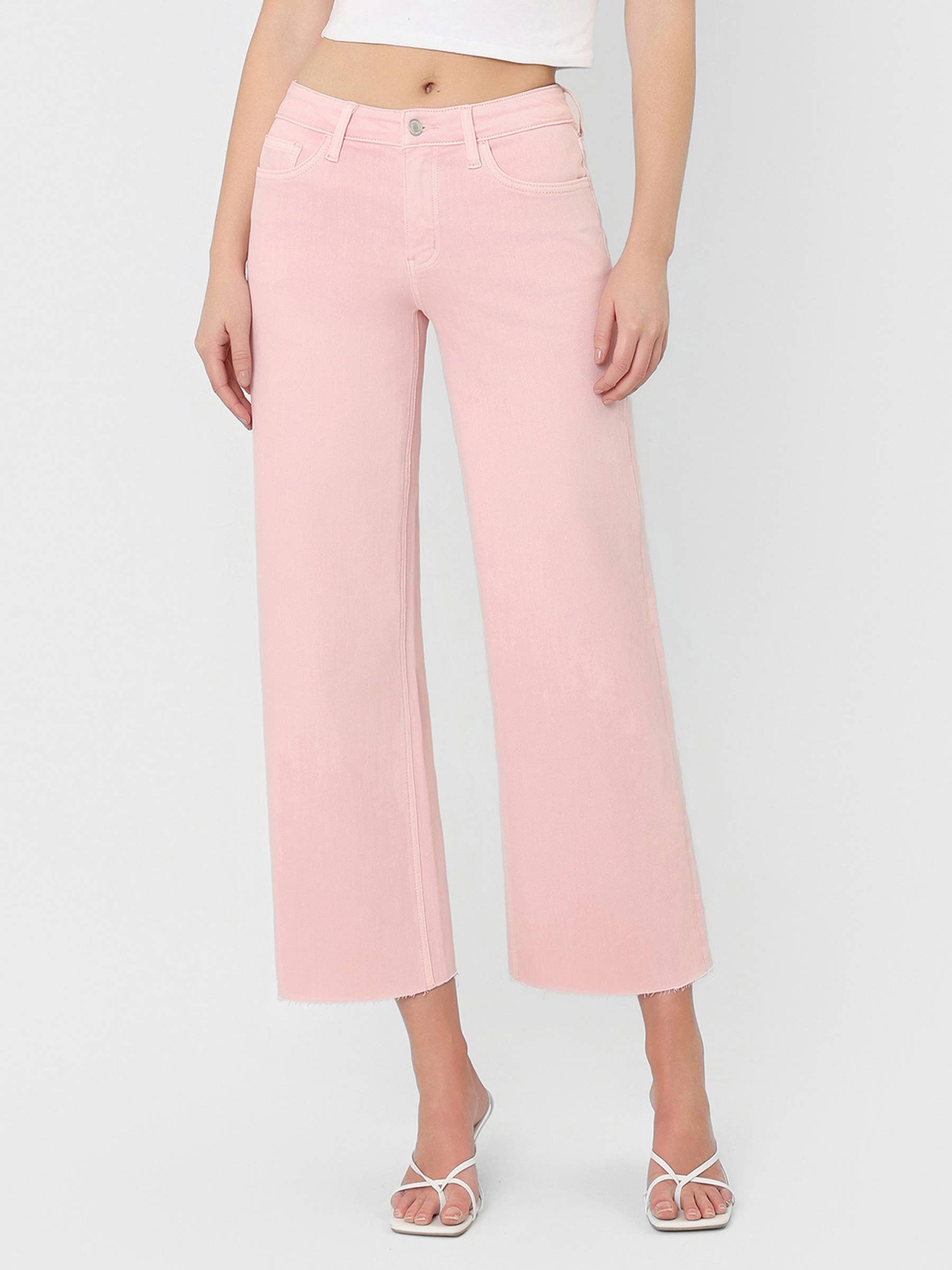 High Rise Crop wide leg cropped jeans in bubblegum pink with raw hem and silver button closure.