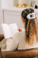 Teleties Flat Round Hair Clip in Coconut white securing braided curly hair on woman reading book.