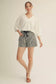 Cloud Kiss Top: white V-neck oversized tee with three-quarter length wide sleeves, worn with striped shorts.