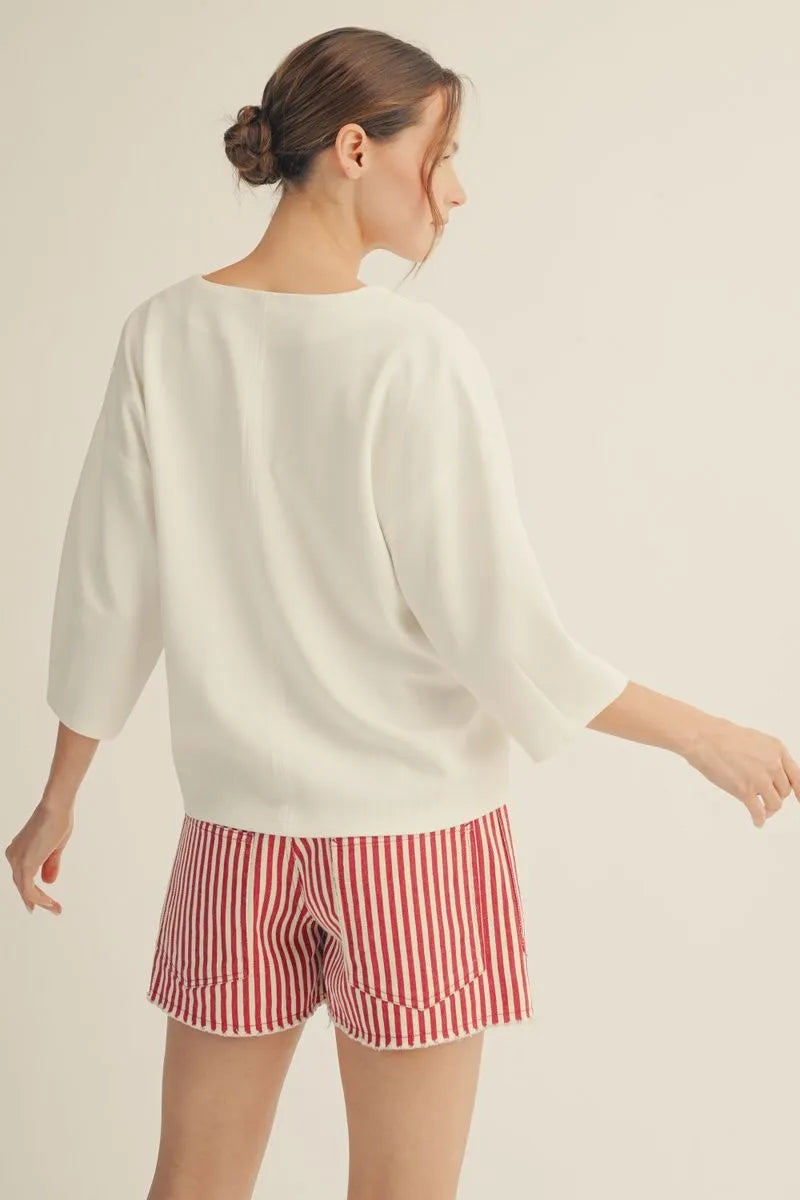 Cloud Kiss Top by Cloud Kiss — women's relaxed white knit top with three-quarter sleeves, worn from behind.