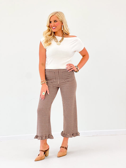 EE Some Gingham Ruffle Hem Pants in brown check pattern with ruffle cuffs, styled with white off-shoulder top on model.