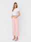 High Rise Crop wide leg jeans in bubblegum pink with raw hem, styled with white crop top and strappy heels.
