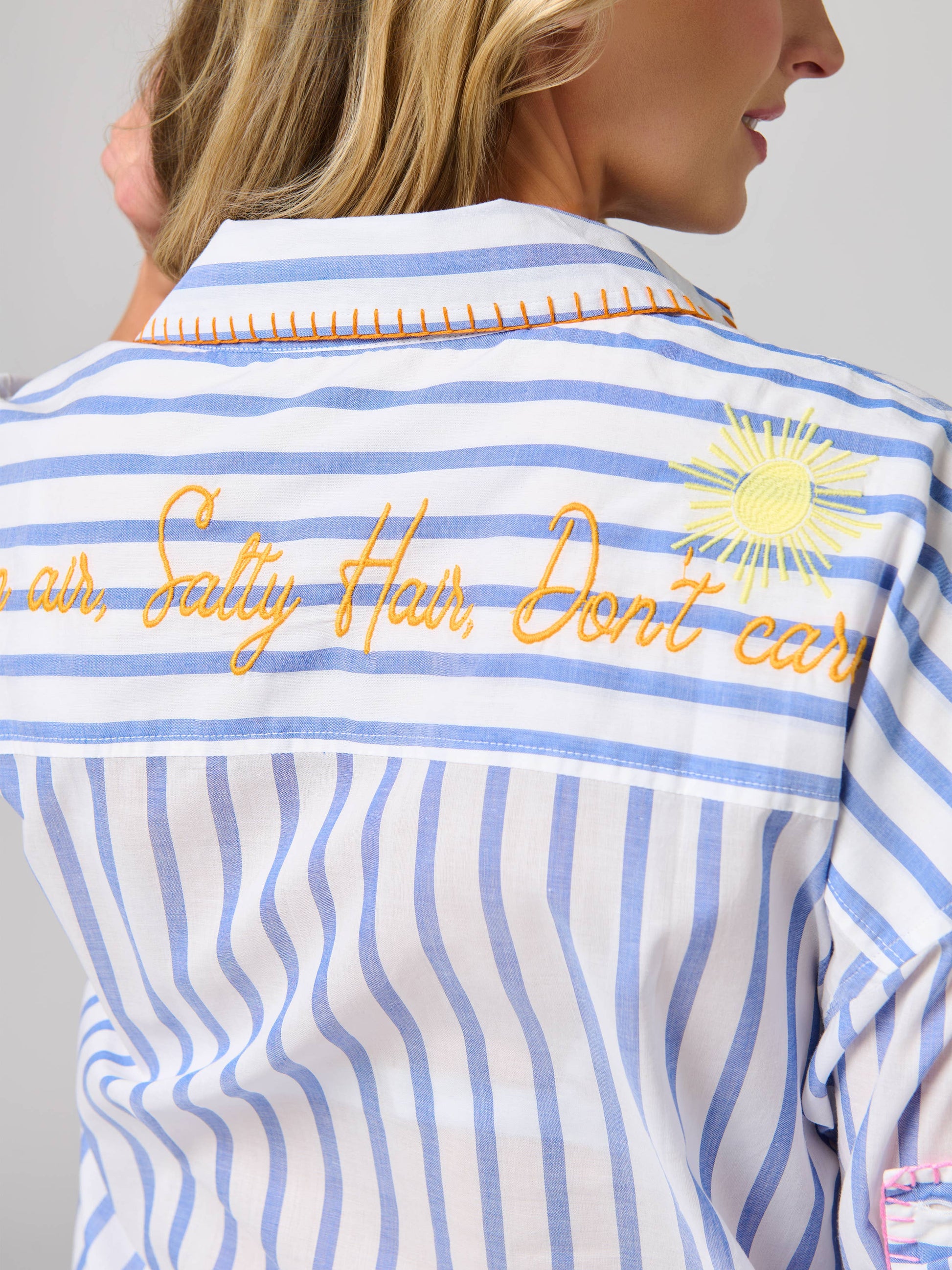 Shiraleah Beach Ocean Air Cover-Up Shirt back view, blue striped with orange embroidered 'Salty Hair, Don't Care' and sun detail.