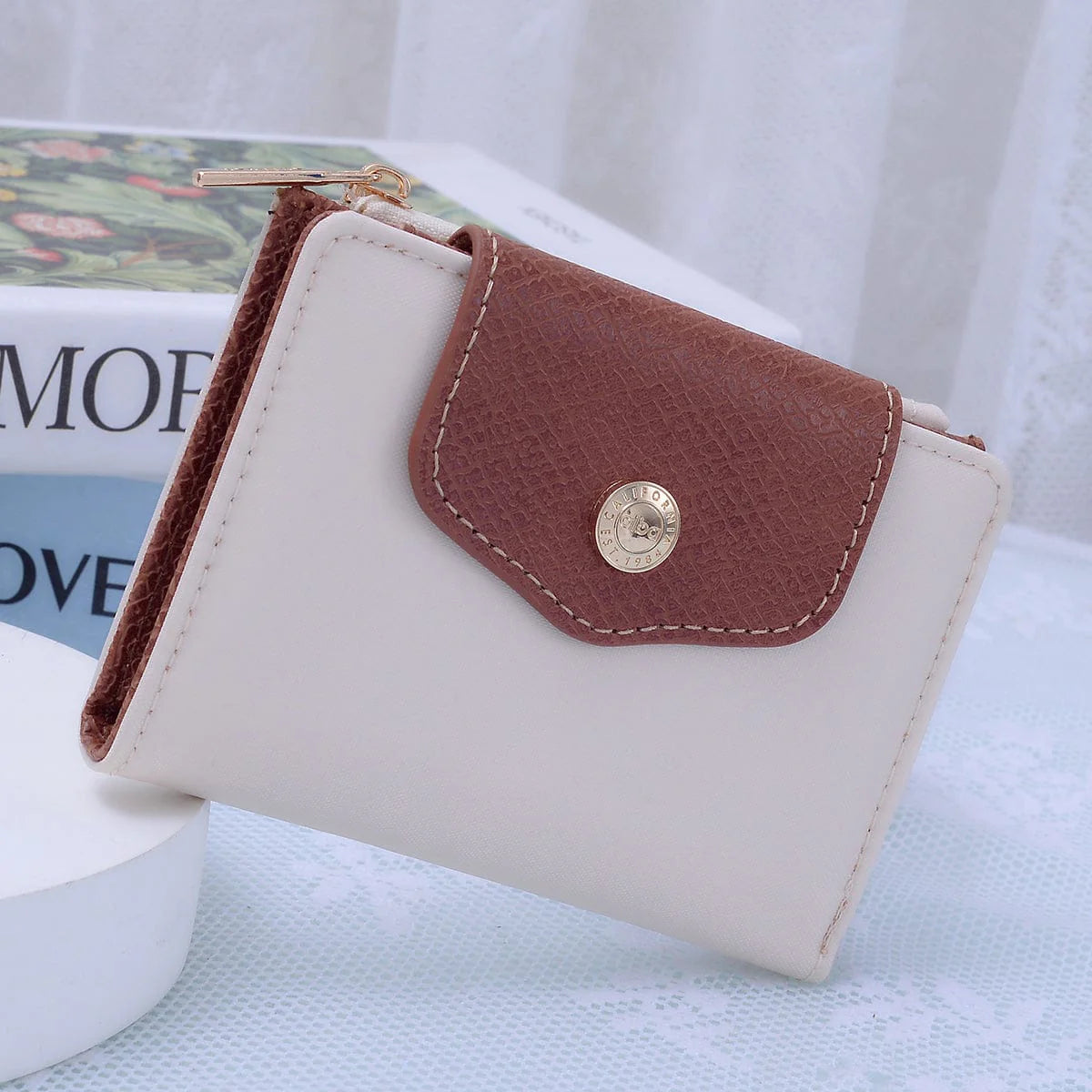 Stephie Nylon Snap Bifold Wallet in Ivory with brown textured flap and gold snap closure.