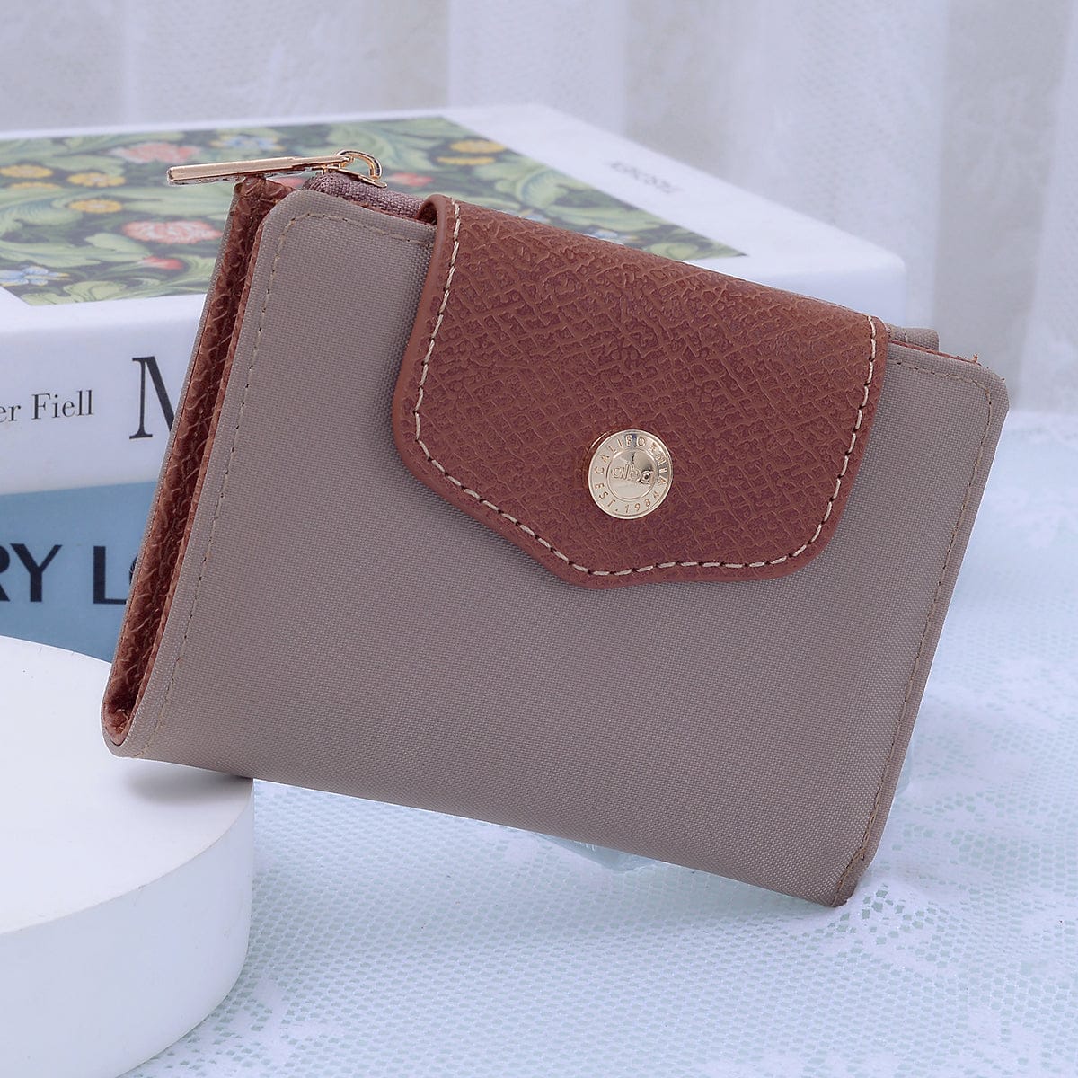 Stephie Nylon Snap Bifold Wallet in Taupe with brown leather flap and gold button closure.