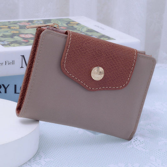 Stephie Nylon Snap Bifold Wallet in Taupe with brown leather flap and gold button closure.
