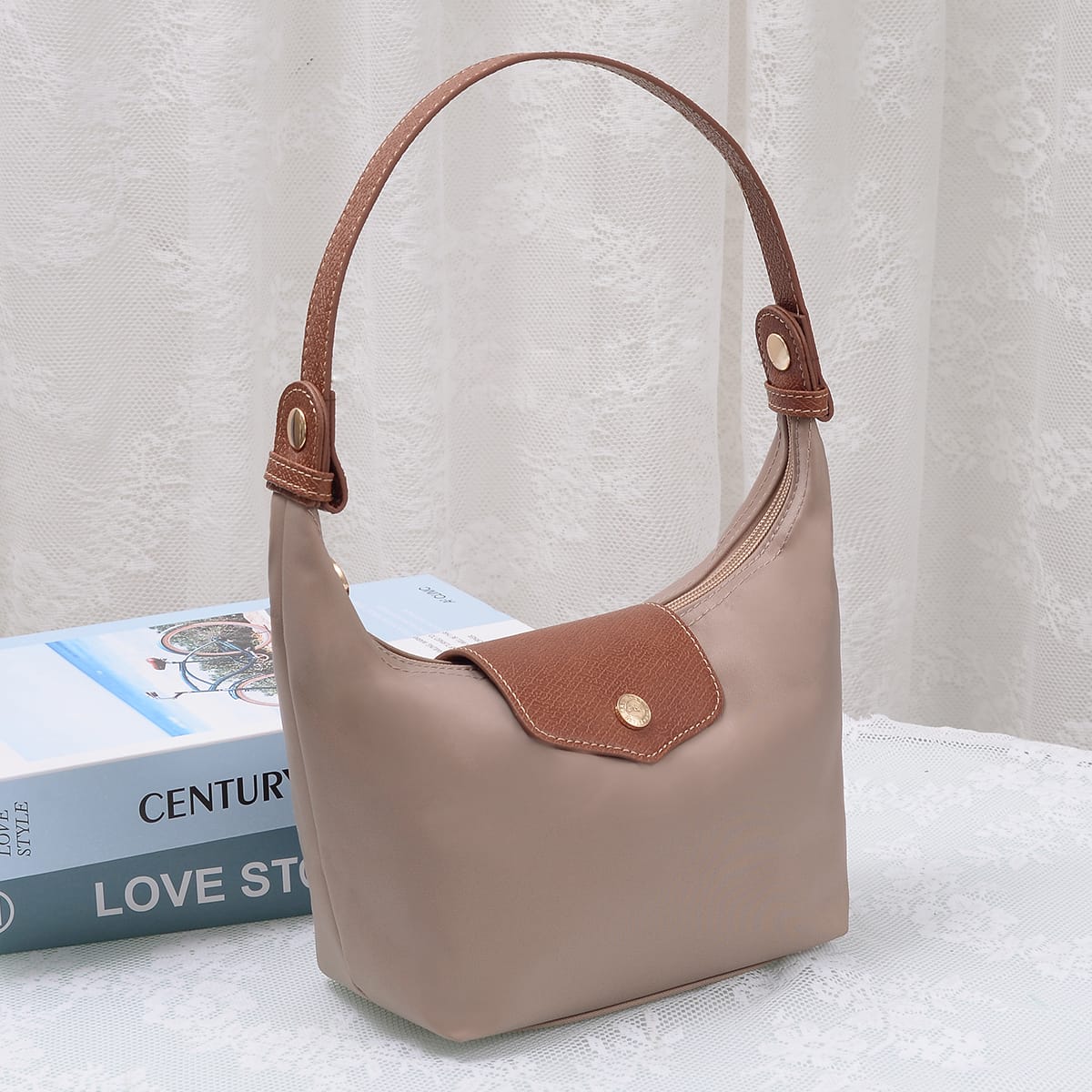 Nora Nylon Bag in Taupe — small hobo-style handbag with tan leather strap and front snap pocket.
