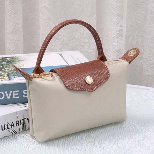 Penny Nylon Mini Crossbody Bag in Clay with brown leather flap closure and top handle.