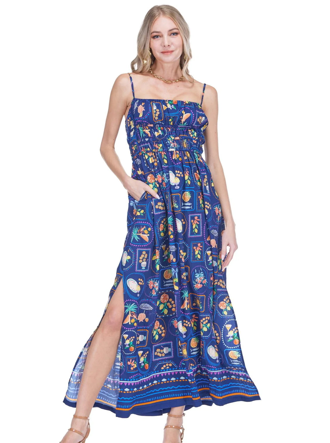 Joy Joy Tuscan sleeveless maxi dress with spaghetti straps, smocked bodice, side slit, and vibrant tile print pattern.