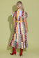 Alden Adair Luna Dress Golden Bouquet, back view, patchwork floral midi dress with puff sleeves, worn with red boots.
