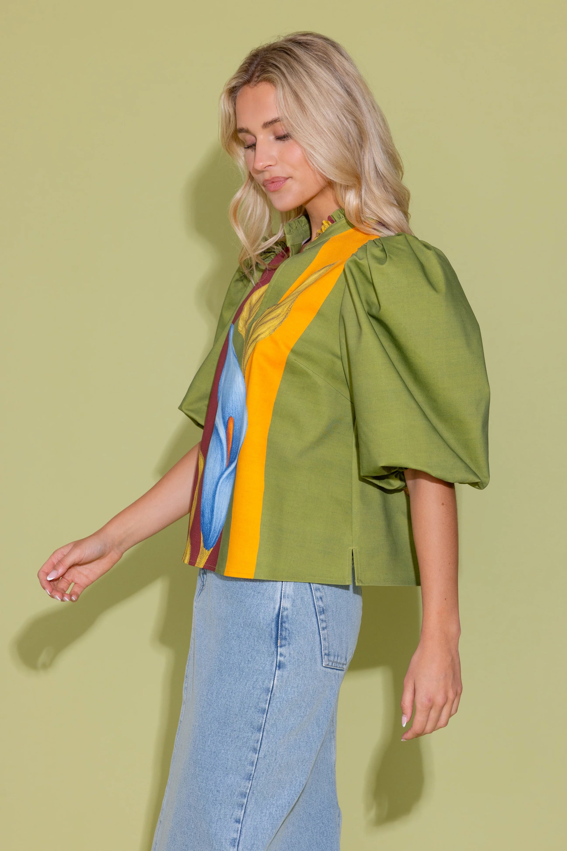 Alden Adair Ali Top Calla Lily — olive green blouse with puff sleeves, floral panel, and ruffled neckline.