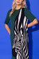 Alden Adair Scout Dress Wild Silhouette in forest green with bold black-and-white zebra intarsia knit panel, worn by model, close-up front view.