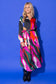 Alden Adair Bronte Dress Solar Vines: model wearing bold multicolor abstract print maxi shirtdress with tie waist, front view.