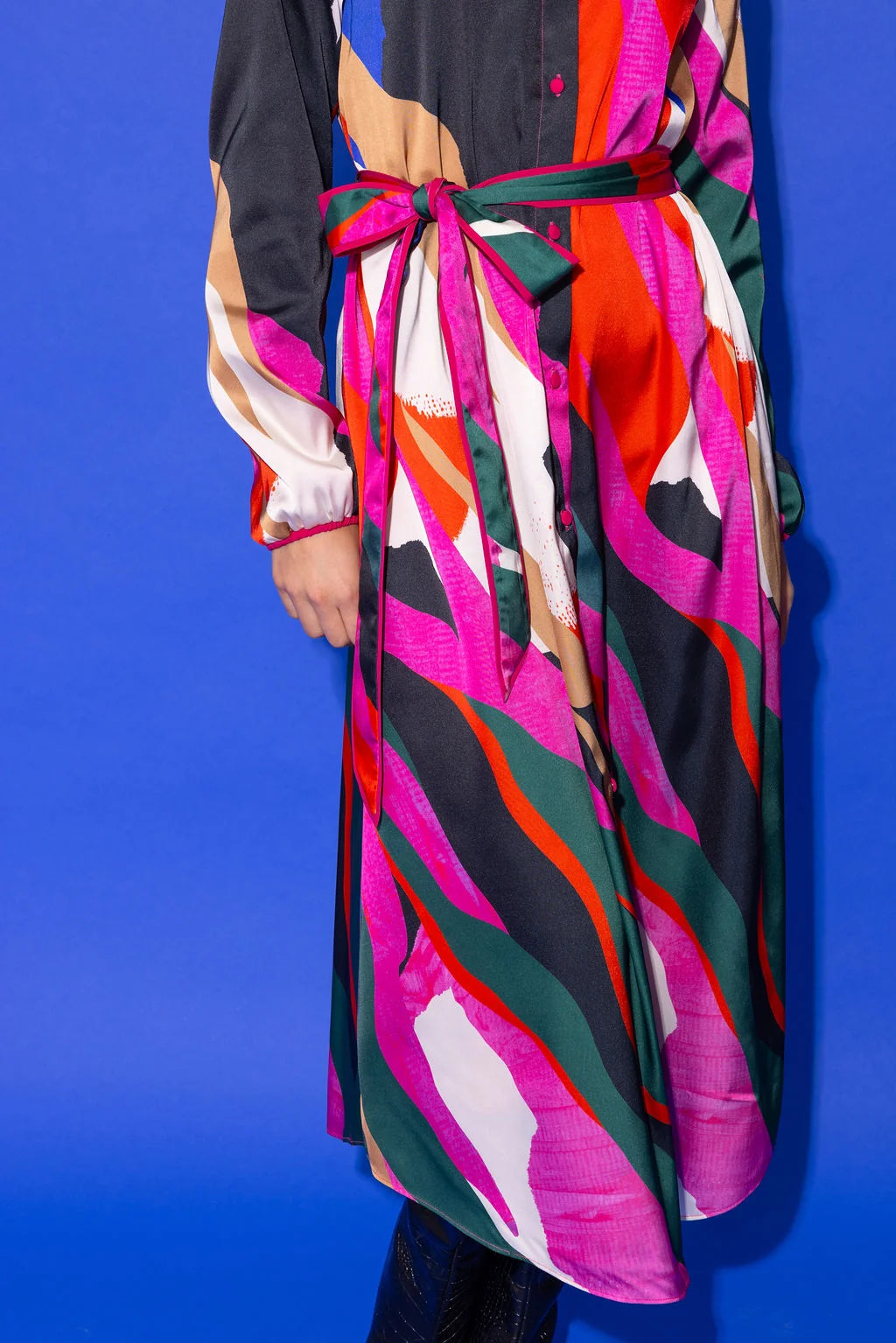 Alden Adair Bronte Dress Solar Vines close-up showing multicolor abstract print with tied sash belt in pink, green, orange, black.