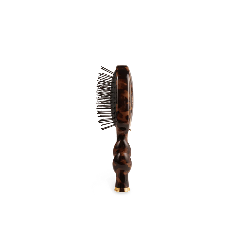 Teleties Mini Detangler Hair Brush in tortoiseshell pattern with bubble handle, black pins, and gold accent tip.