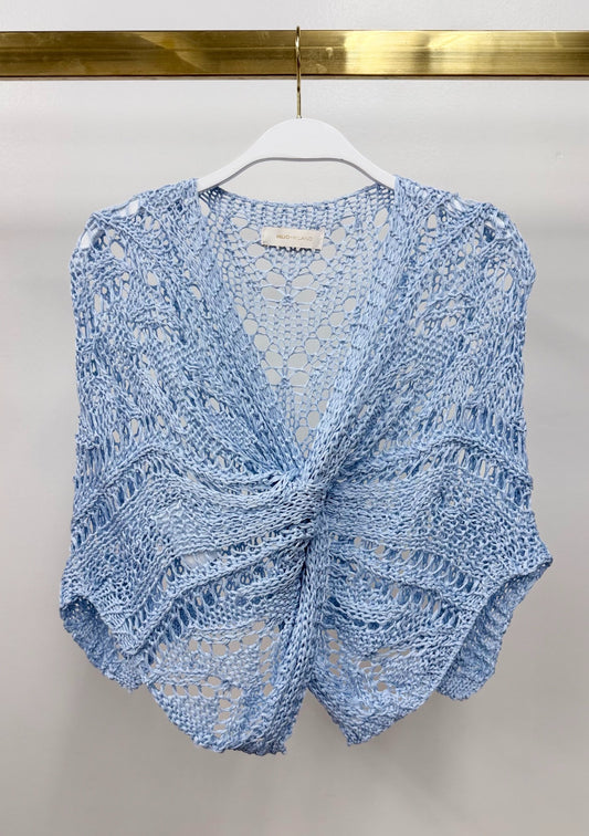 Milio Milano light blue open-weave crochet knit poncho with front twist knot detail, displayed on white hanger.